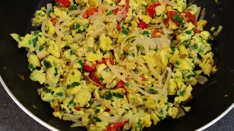 Close up on handmade scrambled eggs sizzling cooked in a cast iron frying pan. Stock Footage 252224333