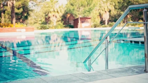 Close-up of the handrails in the pool against the background of blue water Stock Footage 198905778