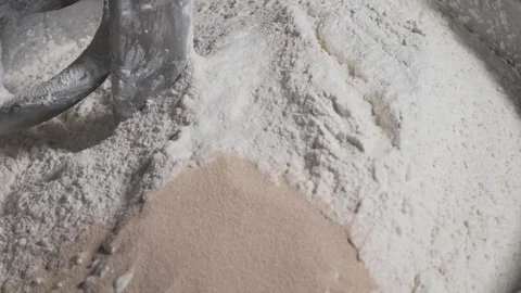 Close up of hands, adding salt on top of yeast and flour in baking machine Stock Footage 113414528