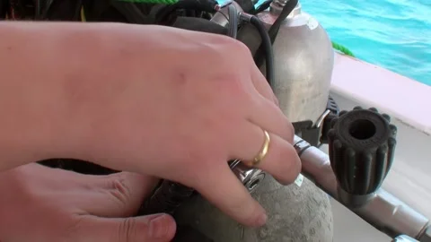 Close-up of hands that adjust scuba tanks, prepare for work for diving divers. Video stock 263836450