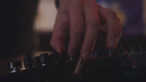 Close up of hands adjusting knobs and parameters on synthesiser musical 動画素材 252785717