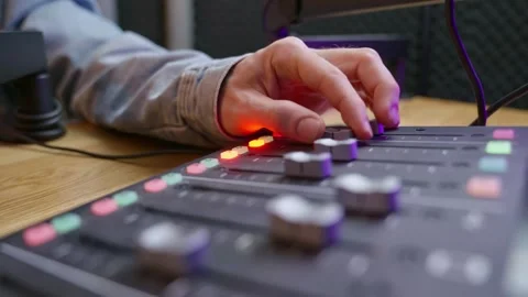 Close-up of hands adjusting knobs on a professional sound engineering console Stock Footage 304971841