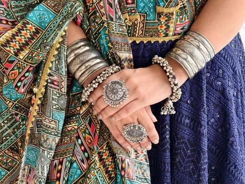  Close-up of hands adorned with oxidized bangles, rings, and bracelets, paired w Stock Photos