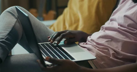 Close-up of the hands of African-looking boy holding laptop on lap and opening Stock Footage 218160962