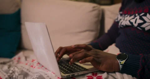 Close-up of hands of African-looking guy typing on laptop keyboard. The boy is 库存影片 211208219