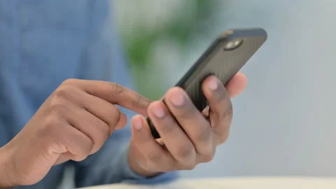 Close Up of Hands of African Man Typing on Smartphone Video stock 146483939