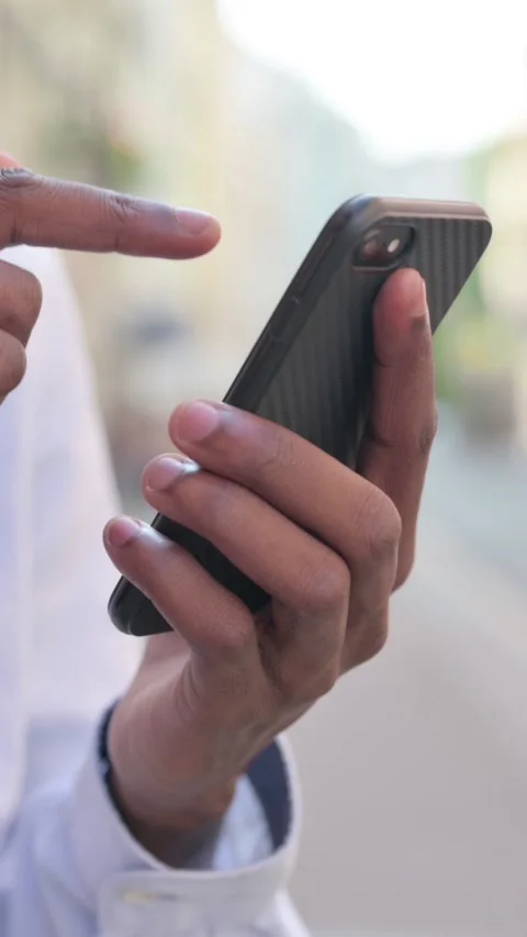 Close up of Hands of African Man using Smartphone, Vertical Video Stock Footage 340025457