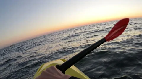 Close up hands and paddle during kayaking in the sea at sunrise - POV, Dutch Stock Footage 156674221