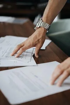 Close-up of hands and papers on the table Stock Photos