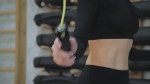 Close-Up of the Hands and Skipping Rope of a Young Athletic Blonde Woman Stock Footage 152758631