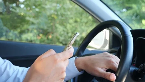 Close-up of hands and steering wheel. A male businessman is driving a car and Stock-Footage 80493728