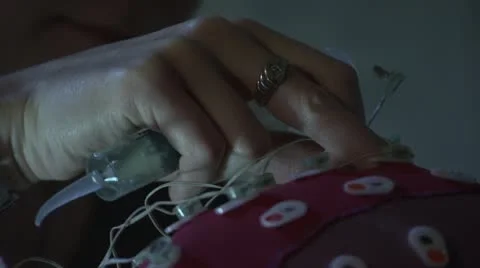 Close up of hands applying brain sensors - short Stock Footage 20448614