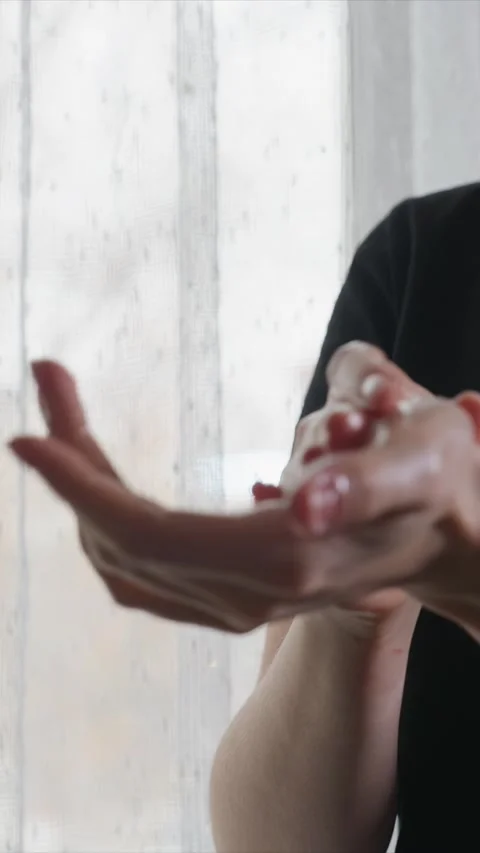 Close up of hands applying cream lotion or oil for hand massage in calm indoor Stock Footage 346793775