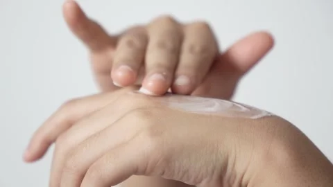 Close-up of hands applying cream or lotion on the skin Stock Footage 323166013