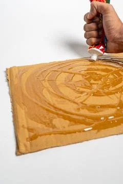 Close up of hands applying rat glue to cardboard Stock Photos