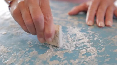 Close up of hands applying surf wax to surfboard Video stock 116852587