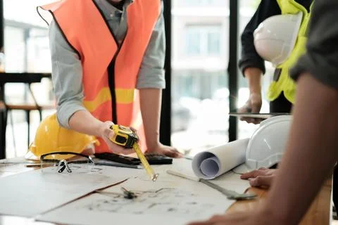 Close up of hand's architects working on blueprints in the office with drawing Stock Photos