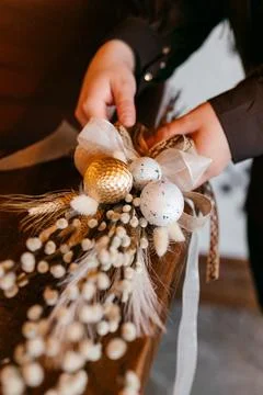 Close-up of hands arranging a dried flower bouquet in warm natural light Stock Photos
