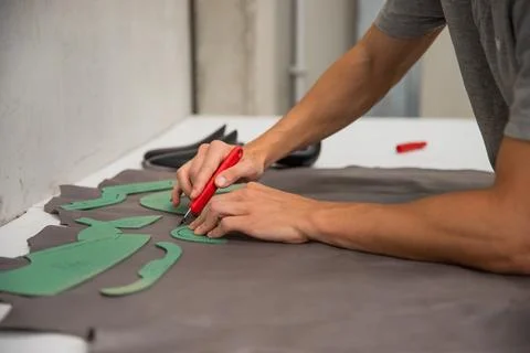 Close-up of the hands of an artisan working on the creation of shoes Stock Photos