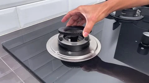 Close up of hands assembling and installing a modern built-in gas stove top Vídeo Stock 330514779