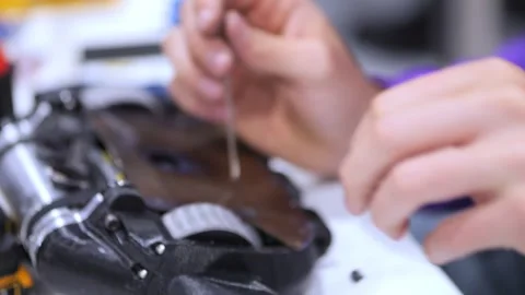 Close-up of hands assembling mechanical components with care Stock Footage 344651594