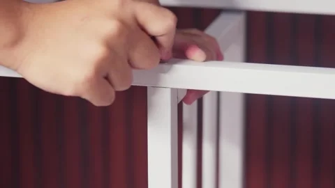 Close-up of Hands Assembling White Metal Furniture Frame Stock Footage 333316278