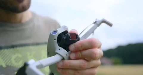 Close Up of Hands Attaching Lens Filter to Drone Camera Stock Footage 345021893