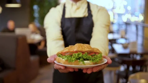 Close up of a hands of barista taking a plate with croissants Stock Footage 148244098