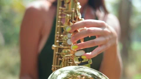Close-up of hands with beautiful manicure playing the golden saxophone. Stock Footage 234022552