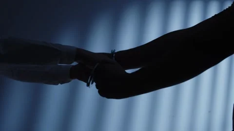 Close-up of Hands Being Handcuffed by Police in Dark Room Video stock 337405964