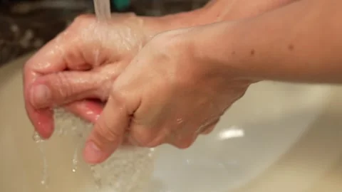Close-up of hands being washed under running water at home Stock Footage 308607406