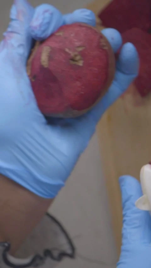 Close-Up of Hands in Blue Gloves Peeling a Beetroot Stock Footage 329143163