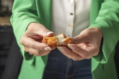 Close-up of hands breaking a cheese-filled snack Stock Photos