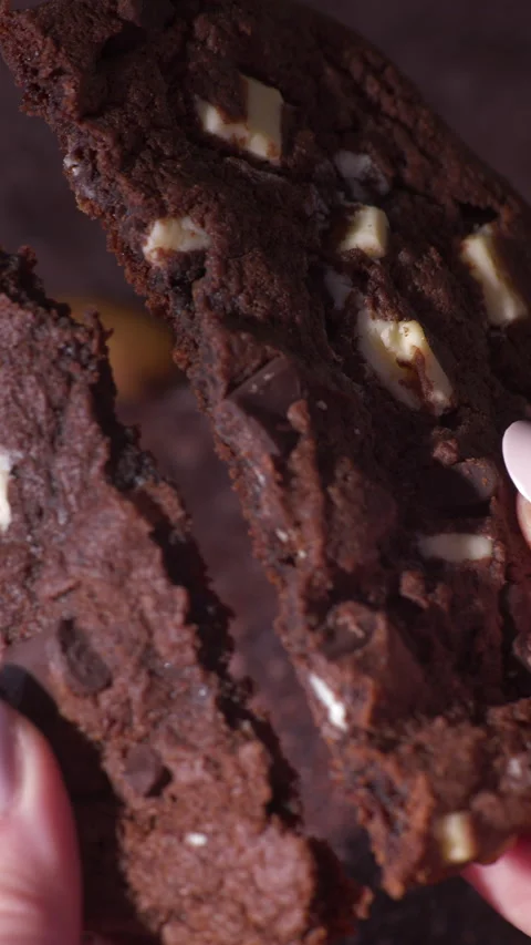 Close Up Hands Breaking Soft Chocolate Cookie With Almond Pieces Stock Footage 331981253