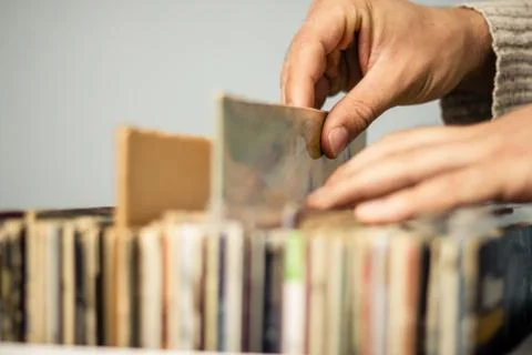 Close up on hands browsing record store Photos
