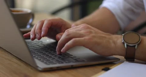 Close up of hands of businessman busy while using laptop in the cafe.Man typing Stock Footage 160771034