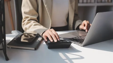 Close up hands businessman doing finances with using calculator and writing.. Stock Footage 327900920