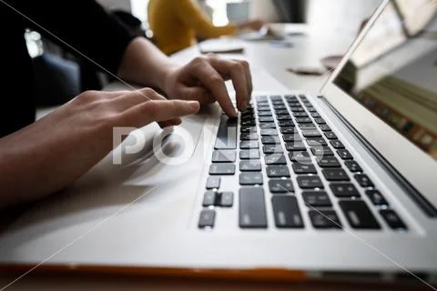 Close-up of hands of businessman typing on a laptop. Stock Photos
