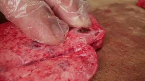Close-up hands of a butcher cut meat - lung. Close-up of a knife for cutting Stock Footage 157811894