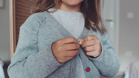 Close up hands button up skill for children Stock Footage 250436170