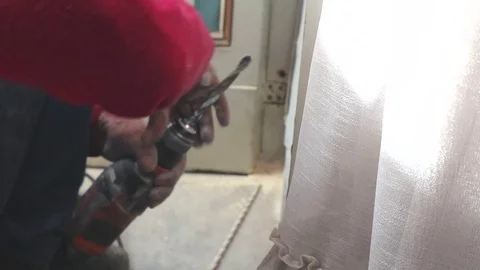 Close-up, hands of a carpenter are drilling a wall Stock Footage 113569910