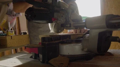 Close up hands of carpenter using circular saw. machine works with sawdust on Video stock 76088925