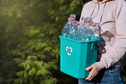 Close-up. hands carry box of plastic for recycling. Environmental consciousne Stock Photos