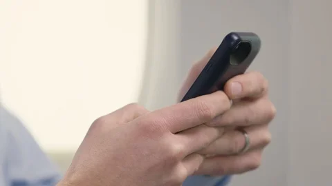 Close up of hands on a cell phone during a flight Stock-Footage 106534883
