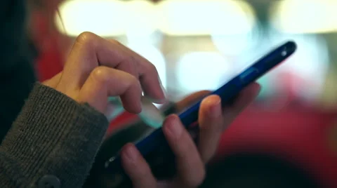 Close up of hands on a cell phone at night in the city Stock Footage 44688084