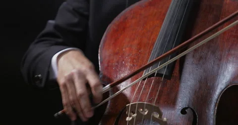 Close-up of the hands of a cellist holding a bow, performing a piece of music on 스톡 동영상 255922383