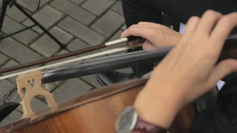 Close-up of the hands of a cellist playing a musical instrument. Stock Footage 163787782
