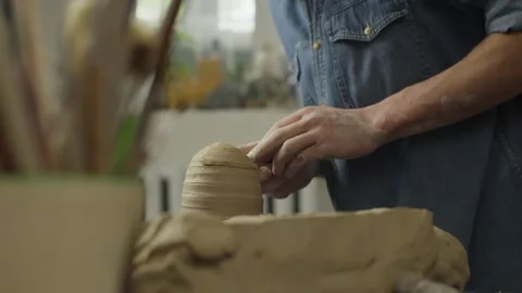 Close-up of the hands of a ceramist making clay products in a workshop on table Stock Footage 244651196