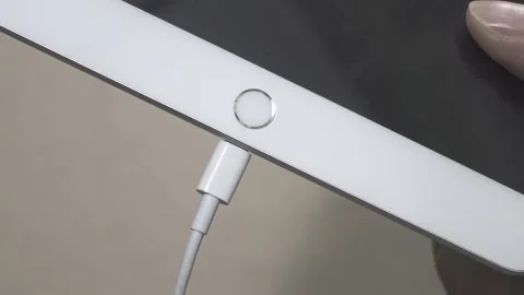 Close-up a hands charging charge tablet computer  Video stock 307069243