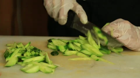 Close up of the hands of a chef chopping cucumber Stock Footage 65481521
